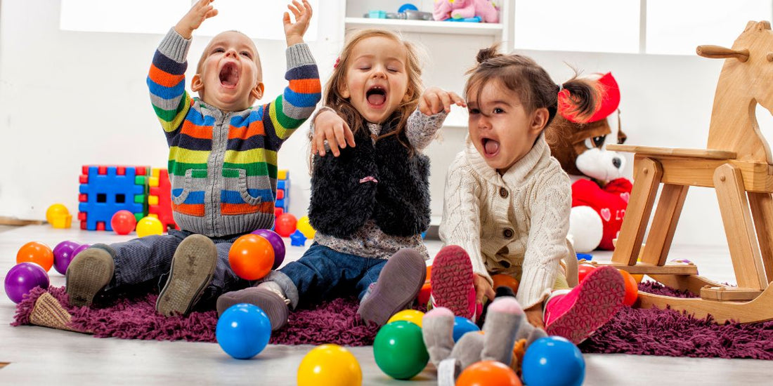 Toddler playing at home with colorful toys